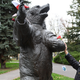 A former Polish soldier touches a statue of Wojtek the bear.